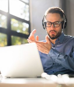 A person watching a webinar on a laptop