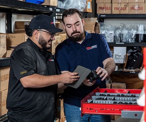 Two men looking at a tablet in a warehouse