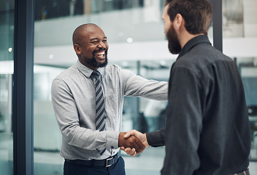 Image of two men shaking hands in an office.