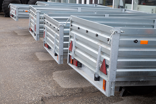 Image of four metal trailer beds.