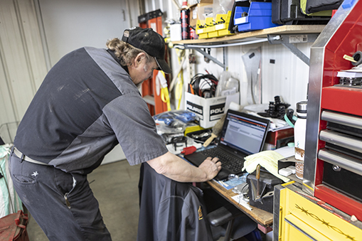 Image of a man working on a laptop.